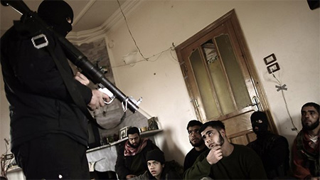 Syrian rebels in Maaret Ikhwan, near Idlib, listen attentively to a trainer showing them how to use a rocket launcher as the civil war escalates across the country